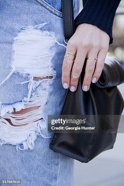 Emily Mercer wearing high waisted ripped One Teaspoon denim skirt, Rag & Bone navy sweater, PaPer minT black leather bag, rings by EF Collection,...