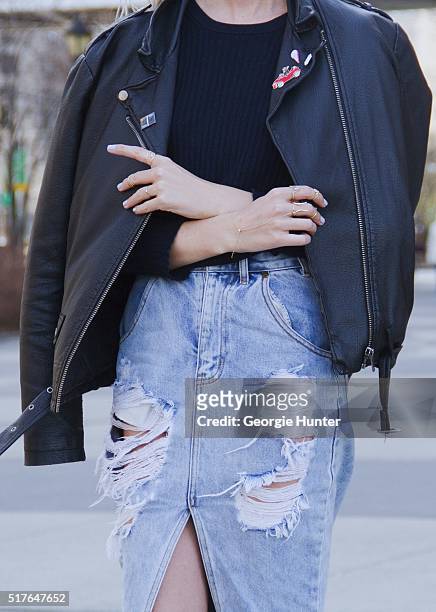 Emily Mercer wearing high waisted ripped One Teaspoon denim skirt, Rag & Bone navy sweater, right hand rings by Zoe Chicco, Michelle Fantaci, Nayla...