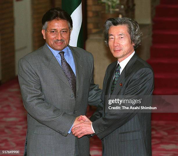 Pakistani President Pervez Musharraf and Japanese Prime Minister Junichiro Koizumi shake hands prior to their meeting at Koizumi's official residence...