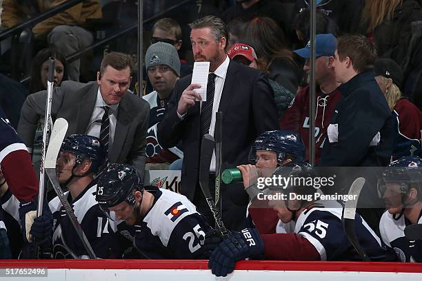 Head coach Patrick Roy of the Colorado Avalanche looks on from the bench as he leads his team against the Minnesota Wild at Pepsi Center on March 26,...