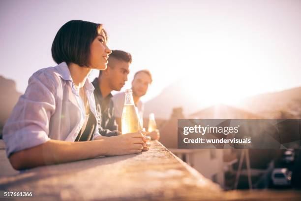 jeune hipster amis, boire de la bière et discutant sur le toit - afterwork photos et images de collection