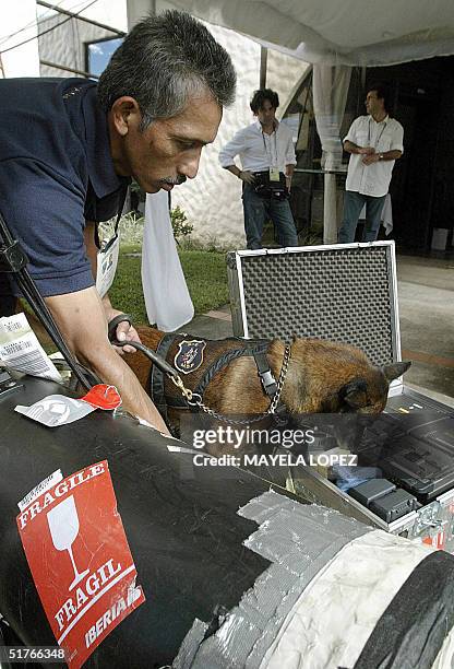 Un policia del escuadron antiexplosivos de la Policia de Costa Rica chequea los equipos de prensa, el 19 de noviembre de 2004, previo a su ingreso al...