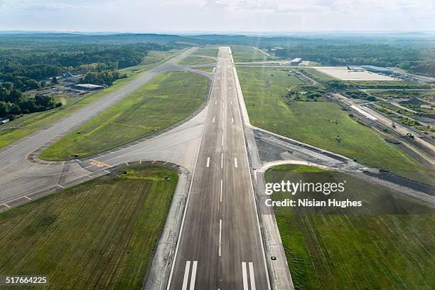 aerial view of airplane landing strip - flugfeld stock-fotos und bilder