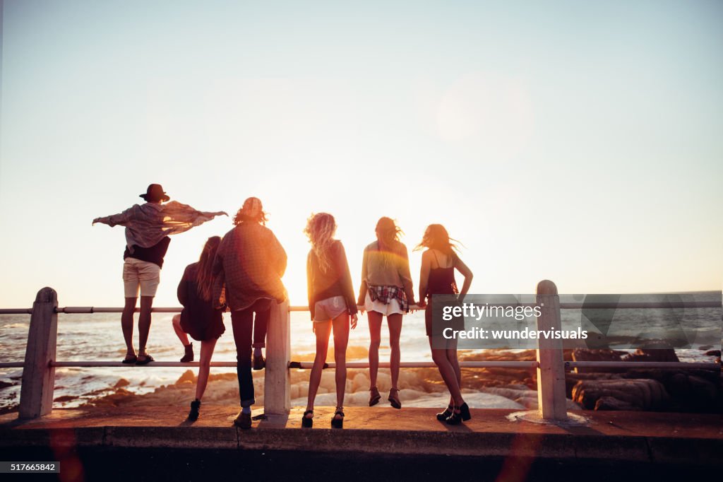 Boho style friends reaching the beach on a road trip