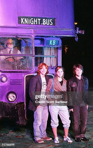 Actor Rupert Grint, Actress Emma Watson and Daniel Radcliffe pose in front of the magical purple Knight bus during the Harry Potter And The Prisoner...