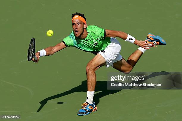 Damir Dzumhur of Bosnia and Herzegovina lunges for a shot against Rafael Nadal of Spain during the Miami Open presented by Itau at Crandon Park...