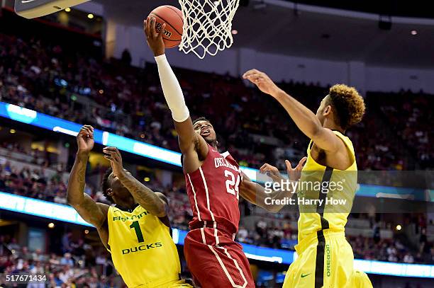 Buddy Hield of the Oklahoma Sooners lays the ball up between Jordan Bell and Tyler Dorsey of the Oregon Ducks in the second half in the NCAA Men's...