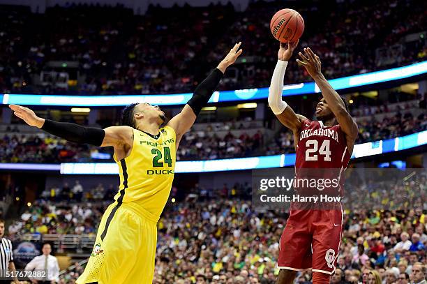 Buddy Hield of the Oklahoma Sooners shoots over Dillon Brooks of the Oregon Ducks in the second half in the NCAA Men's Basketball Tournament West...