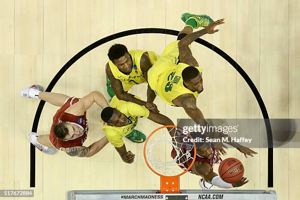 Buddy Hield of the Oklahoma Sooners shoots Elgin Cook of the Oregon Ducks in the second half in the NCAA Men's Basketball Tournament West Regional...