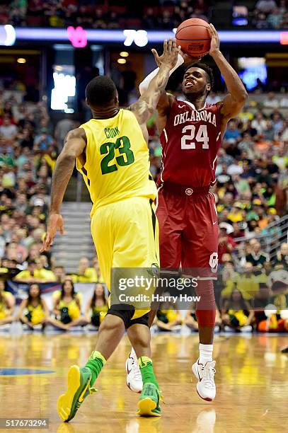 Buddy Hield of the Oklahoma Sooners shoots a three-pointer against Elgin Cook of the Oregon Ducks in the second half in the NCAA Men's Basketball...