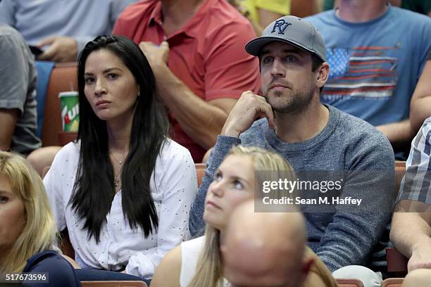 Actress Olivia Munn and Aaron Rodgers of the Green Bay Packers watch the NCAA Men's Basketball Tournament West Regional Final at Honda Center on...