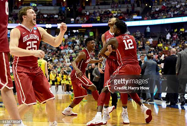 Cole, Isaiah Cousins and Khadeem Lattin of the Oklahoma Sooners celebrate their 80-68 victory against the Oregon Ducks in the NCAA Men's Basketball...