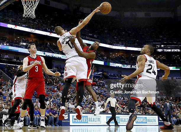 Jonas Valanciunas of the Toronto Raptors blocks a shot from Toney Douglas of the New Orleans Pelicans during a game at the Smoothie King Center on...