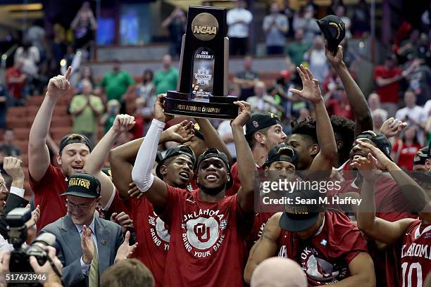 Buddy Hield of the Oklahoma Sooners holds up the West Regional trophy after the Sooners 80-68 victory against the Oregon Ducks in the NCAA Men's...