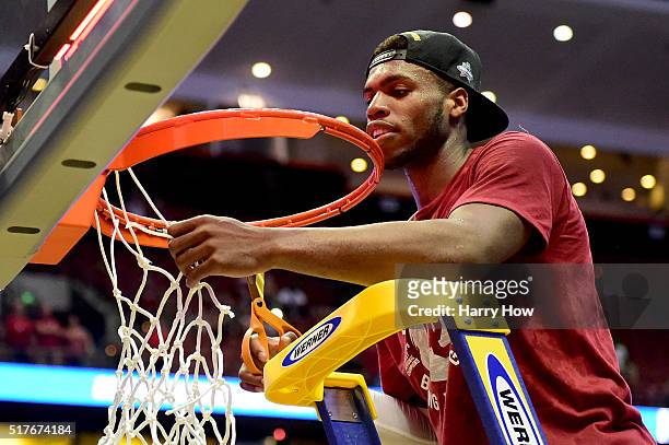 Buddy Hield of the Oklahoma Sooners cuts down a piece of the net after the Sooners 80-68 victory against the Oregon Ducks in the NCAA Men's...