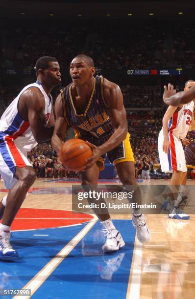 Ron Artest of the Indiana Pacers drives against Antonio McDyess of the Detroit Pistons on November 19, 2004 during their game at the Palace of Auburn...