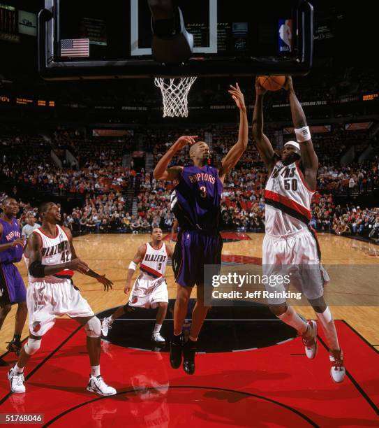 Zach Randolph of the Portland Trail Blazers takes the ball to the basket against Loren Woods of the Toronto Raptors during a game at The Rose Garden...