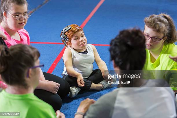group of special needs girls with instructor in gym - little people stock pictures, royalty-free photos & images