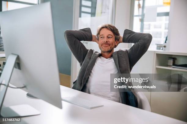executive mature man relaxing in office chair - dipping stock pictures, royalty-free photos & images