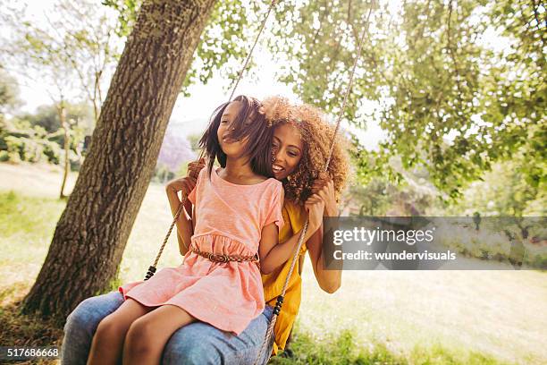 adorable mom and daughter spends some quality time together. - swinging stock pictures, royalty-free photos & images