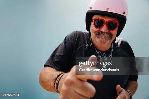 Funny grandpa with pink helmet and heart sunglasses Funny grandpa with pink helmet and heart sunglasses