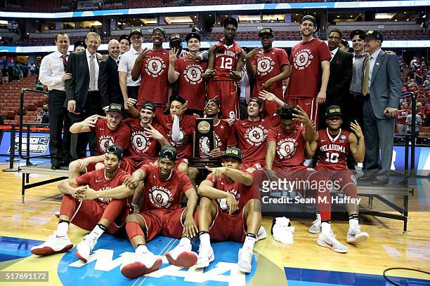 The Oklahoma Sooners pose after beating the Oregon Ducks 80-68 in the NCAA Men's Basketball Tournament West Regional Final at Honda Center on March...