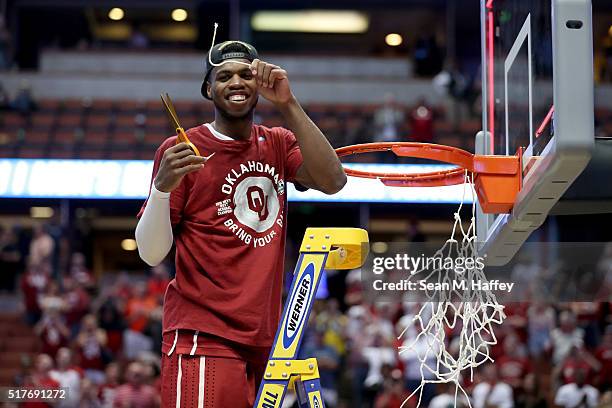 Buddy Hield of the Oklahoma Sooners smiles after cutting a piece of the net after the Sooners 80-68 victory against the Oregon Ducks in the NCAA...