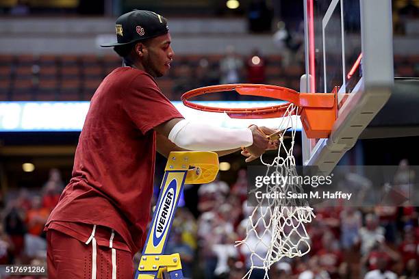 Buddy Hield of the Oklahoma Sooners cuts down a piece of the net after the Sooners 80-68 victory against the Oregon Ducks in the NCAA Men's...