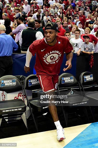 Buddy Hield of the Oklahoma Sooners climbs back onto the court after celebrating with fans after the Sooners 80-68 victory against the Oregon Ducks...