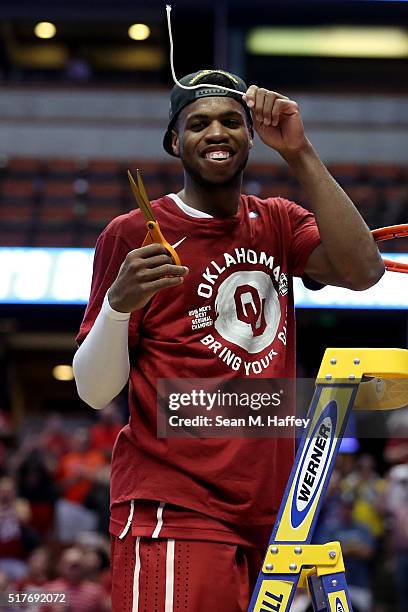 Buddy Hield of the Oklahoma Sooners smiles after cutting a piece of the net after the Sooners 80-68 victory against the Oregon Ducks in the NCAA...