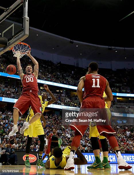 Ryan Spangler of the Oklahoma Sooners dunks the ball in front of Chris Boucher of the Oregon Ducks in the first half in the NCAA Men's Basketball...
