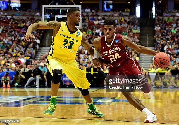 Buddy Hield of the Oklahoma Sooners drives on Elgin Cook of the Oregon Ducks in the second half in the NCAA Men's Basketball Tournament West Regional...