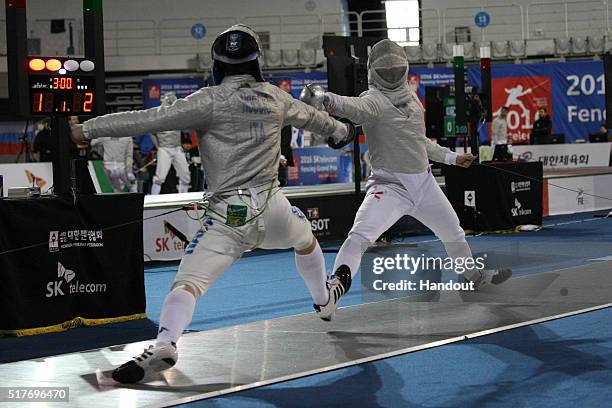 In this handout image provided by the FIE, Riccardo Nuccio of Italy and Chak Man Chow of Hong Kong compete during the individual Men's Sabre match...