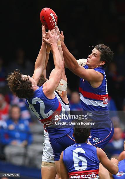 Liam Picken of the Bulldogs, Lee Spurr of the Dockers and Tom Boyd of the Bulldogs compete for a mark during the round one AFL match between the...