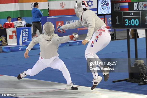 In this handout image provided by the FIE, Andrey Korshunov of Russia and Han Shin Cho of Korea compete during the individual Men's Sabre match...