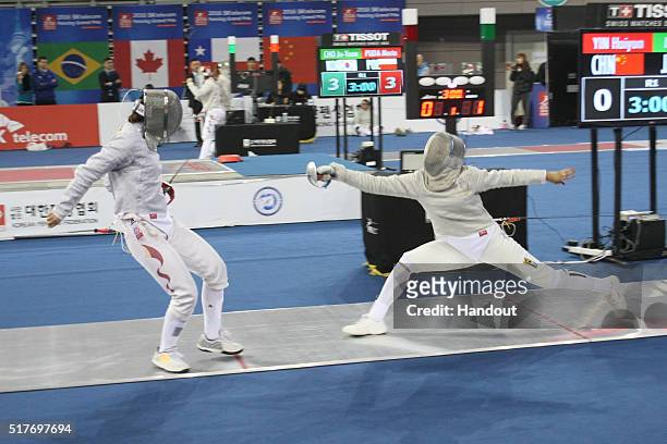 In this handout image provided by the FIE, Haiyan Yin of China and Alison Miller of Jamaica compete during the individual Women's Sabre match during...