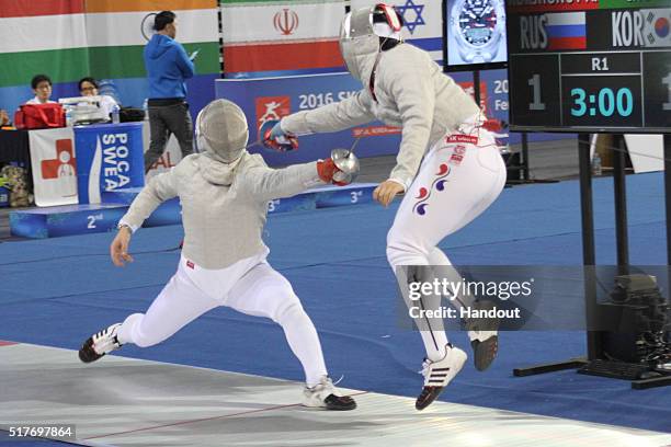 In this handout image provided by the FIE, Andrey Korshunov of Russia and H Choi of Korea compete during the individual Men's Sabre match during day...