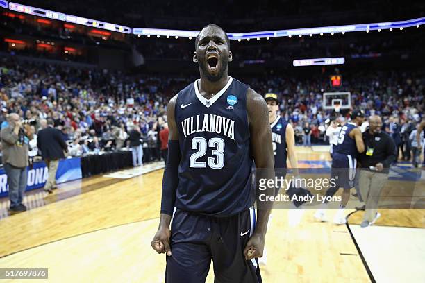 Daniel Ochefu of the Villanova Wildcats celebrates defeating the Kansas Jayhawks 64-59 during the 2016 NCAA Men's Basketball Tournament South...