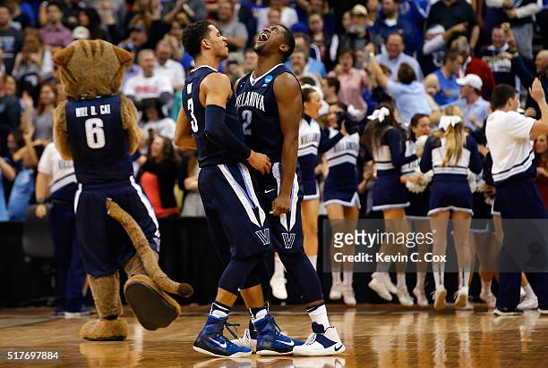 Josh Hart of the Villanova Wildcats and Kris Jenkins celebrate defeating the Kansas Jayhawks 64-59 during the 2016 NCAA Men's Basketball Tournament...