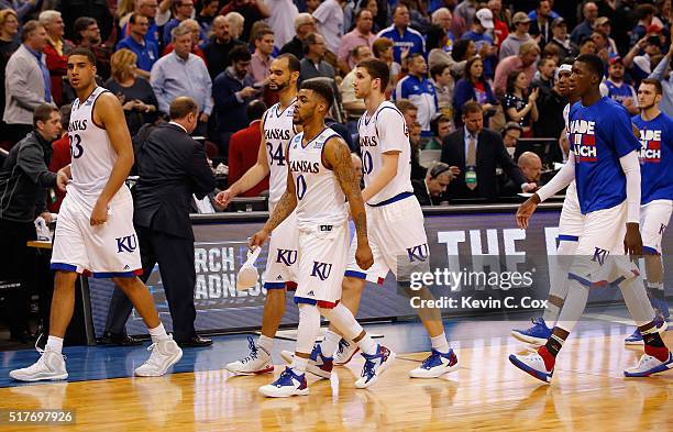 Landen Lucas of the Kansas Jayhawks, Perry Ellis, Frank Mason III, and Sviatoslav Mykhailiuk react after being defeated by the Villanova Wildcats...