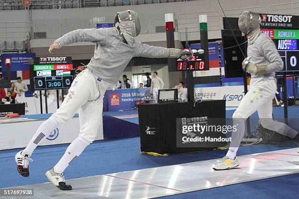 In this handout image provided by the FIE, Evan Prochniak of the USA and Jasper Rowley of Australia compete during the individual Men's Sabre match...