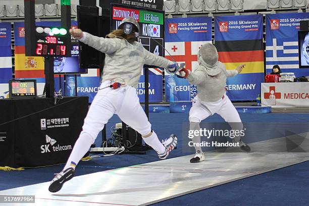 In this handout image provided by the FIE, Zhovnir Olga of Ukraine and Lee Rajin of Korea compete during the individual Women's Sabre match during...