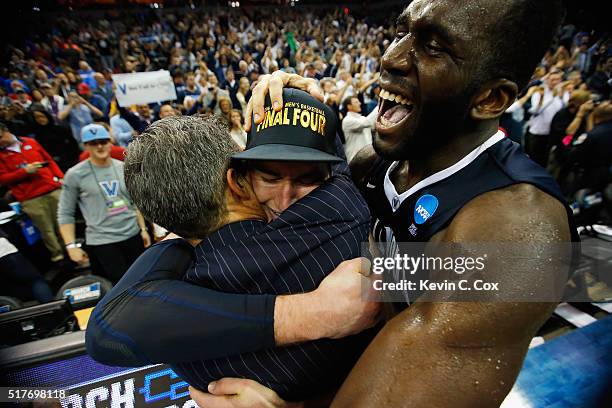 Head coach Jay Wright of the Villanova Wildcats, Ryan Arcidiacono, and Daniel Ochefu celebrate defeating the Kansas Jayhawks 64-59 during the 2016...