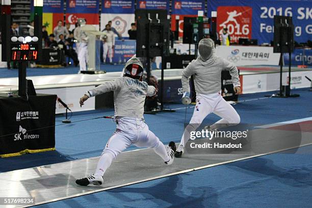 In this handout image provided by the FIE, Kenjo Hoshino of Japan and H. Cho of Korea compete during the individual Men's Sabre match during day 1 of...