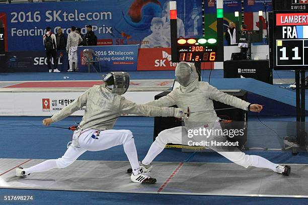 In this handout image provided by the FIE, Maxence Lambert of France and Lee Inho of Korea compete during the individual Men's Sabre match during day...