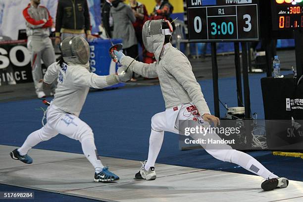 In this handout image provided by the FIE, Tabor Martl of ESA and Won Junho of Korea compete during the individual Men's Sabre match during day 1 of...