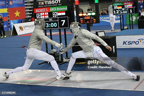 In this handout image provided by the FIE, Sandro Bazadze of Georgia and Amer Mohamed of Egypt compete during the individual Men's Sabre match during...