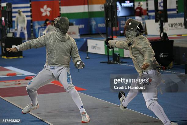 In this handout image provided by the FIE, Luca Curatoli of Italy and Maxence Lambert of France compete during the individual Men's Sabre match...