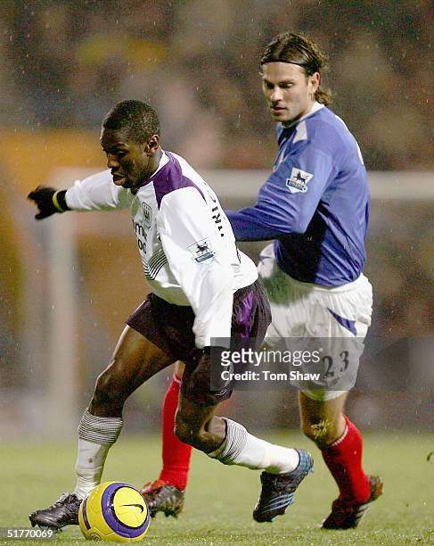 Shaun Wright-Phillips of Manchester City tussles with Patrik Berger of Portsmouth during the Barclays Premiership match between Portsmouth and...