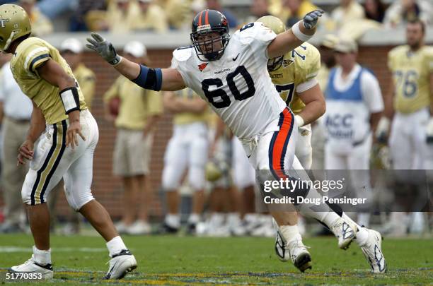 Andrew Hoffman of the Virginia Cavaliers sheds the block of Kyle Wallace of the Georgia Tech Yellow Jackets as he pressures quarterback Reggie Ball...